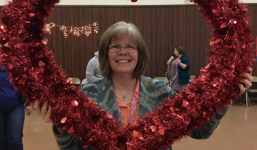 Woman holding a heart wreath