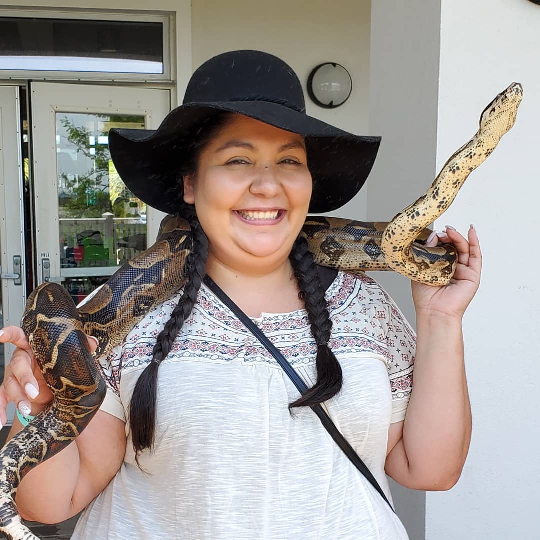 Briana with a snake around her shoulders